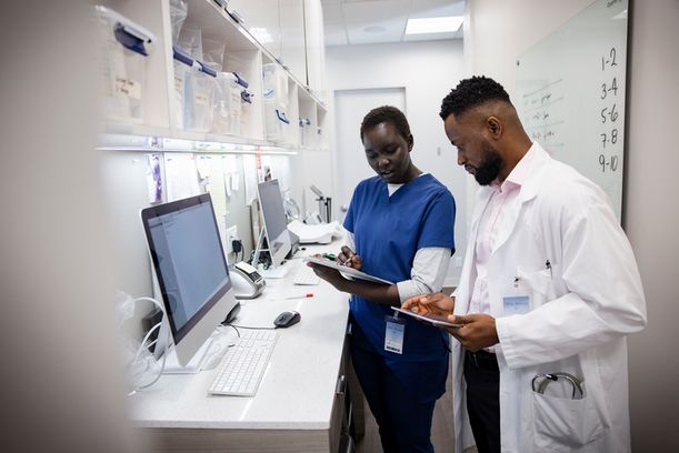 Doctor and nurse with digital tablet consulting in clinic