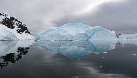 A panoramic image of an iceberg and its reflexion